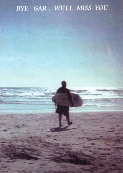 Gary walking to ocean carrying a surfboard